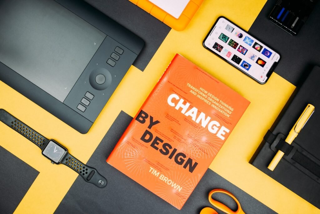 Change by Design by Tim Brown book beside smartphone